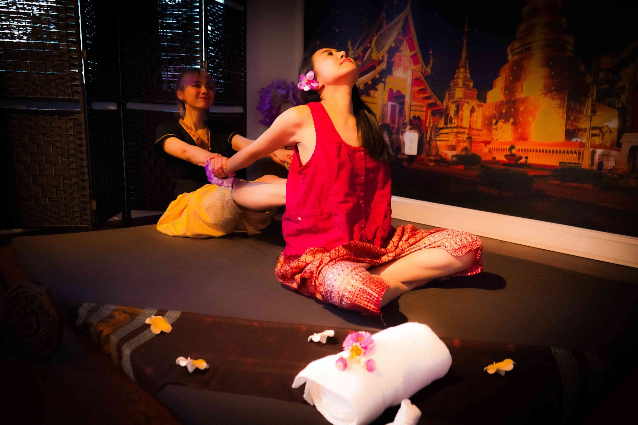 Therapist performing traditional Thai floor massage at Bloom Thai Therapy in Arlington VA during the holiday season
